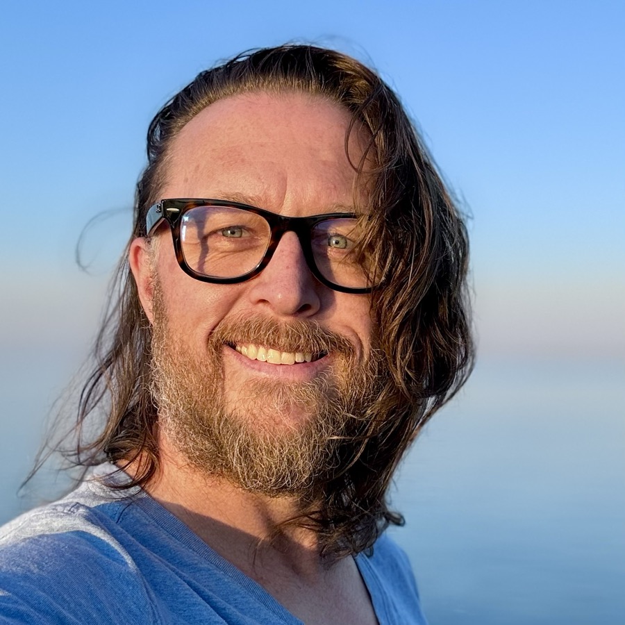 Jason Arkley, outdoors near the water